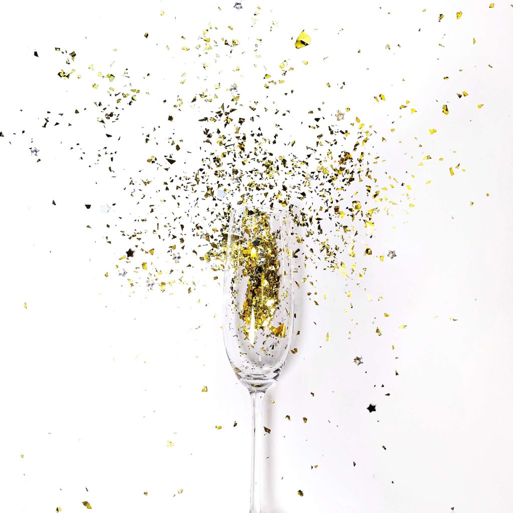 Confetti coming out of a glass, signifying the celebratory mood after successful CIF bid applications.