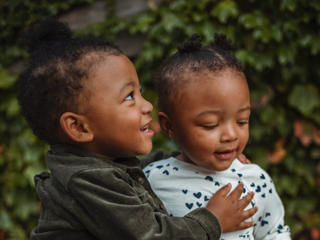 Two young children smiling to represent how architecture can help young people's mental health.