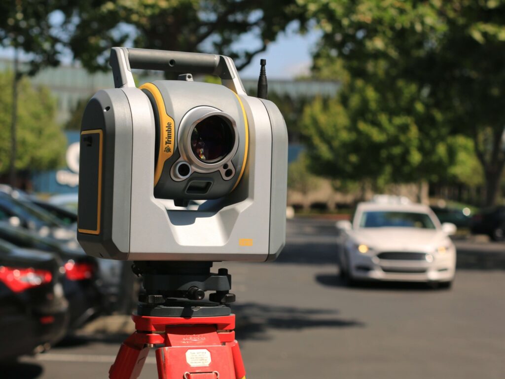 An image of a theodolite to represent geospatial surveying work.