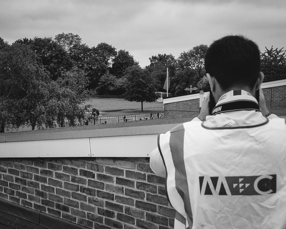 M+C staff looking out on a school field